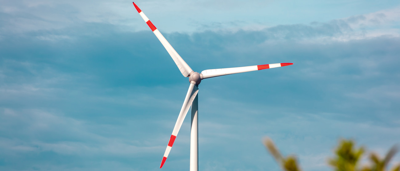 Turbina eolica con cielo blu – immagine simbolica dell’acquisizione di un parco eolico in Germania da parte di Repower.
