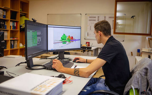 Disegnatore in formazione davanti a progetti tecnici